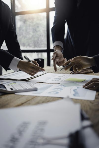 Businessmen meeting to plan, analyze, graph and chart business growth. to plan for new business Businessmen meeting to plan, analyze, graph and chart business growth. to plan for new business
